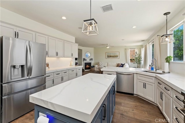 8581 Camino Limon Rd, Corona, CA 92883 - kitchen with appliances with stainless steel finishes, a sink, open floor plan, white cabinetry, and recessed lighting
