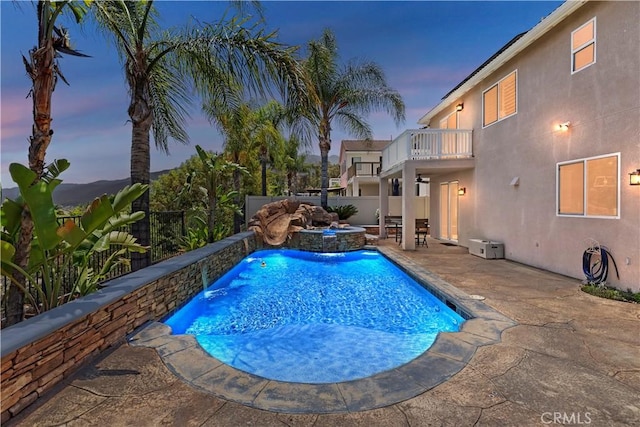 8581 Camino Limon Rd, Corona, CA 92883 - pool at dusk with a fenced backyard, a patio area, and an in-ground hot tub
