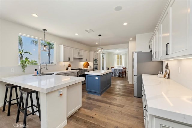 8581 Camino Limon Rd, Corona, CA 92883 - kitchen with a sink, appliances with stainless steel finishes, a center island, recessed lighting, and a peninsula