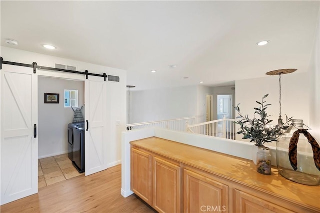 8581 Camino Limon Rd, Corona, CA 92883 - kitchen featuring separate washer and dryer, a barn door, light wood finished floors, recessed lighting, and baseboards