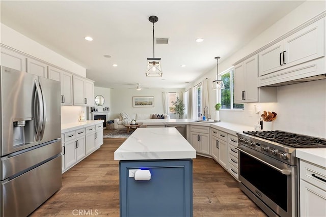 8581 Camino Limon Rd, Corona, CA 92883 - kitchen featuring stainless steel appliances, open floor plan, recessed lighting, a kitchen island, and pendant lighting