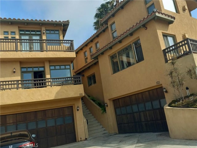 121 Loma Ln, San Clemente, CA 92672 - view of property featuring an attached garage, stairway, and concrete driveway