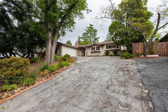4526 La Granada Way, La Canada Flintridge, CA 91011 - ranch-style house with asphalt driveway, an attached garage, stucco siding, and a chimney