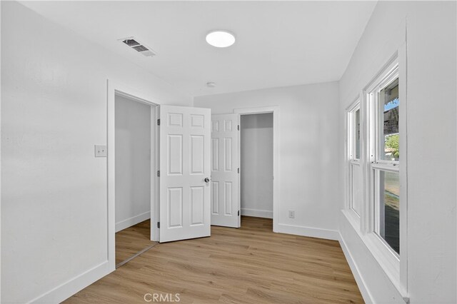 401 Cypress St, Bakersfield, CA 93304 - unfurnished bedroom with baseboards and light wood-type flooring