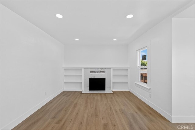 401 Cypress St, Bakersfield, CA 93304 - unfurnished living room with light wood-type flooring, recessed lighting, and a fireplace