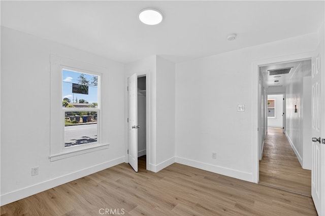 401 Cypress St, Bakersfield, CA 93304 - unfurnished bedroom with baseboards and light wood-style flooring