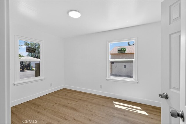 401 Cypress St, Bakersfield, CA 93304 - empty room with light wood-style floors and baseboards