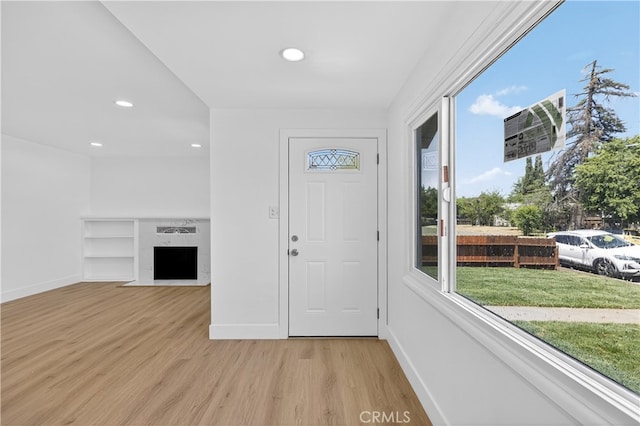 401 Cypress St, Bakersfield, CA 93304 - foyer entrance with healthy amount of natural light, light wood-style floors, baseboards, a fireplace with flush hearth, and recessed lighting