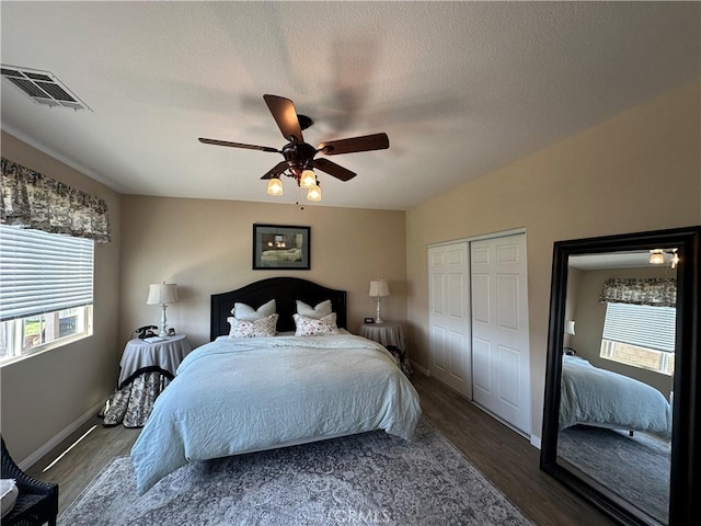 2408 Driftwood Dr, Rosamond, CA 93560 - bedroom with multiple windows, wood finished floors, baseboards, and a textured ceiling