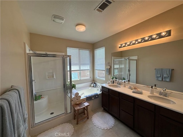 2408 Driftwood Dr, Rosamond, CA 93560 - full bath featuring a shower stall, a bath, double vanity, a textured ceiling, and tile patterned floors