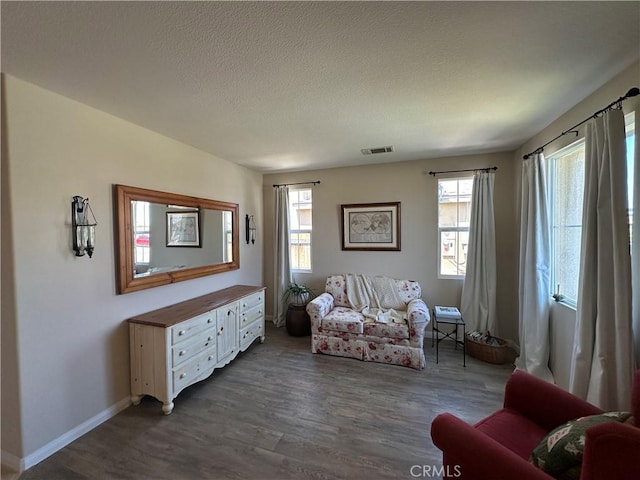 2408 Driftwood Dr, Rosamond, CA 93560 - living room featuring dark wood finished floors, healthy amount of natural light, a textured ceiling, and baseboards