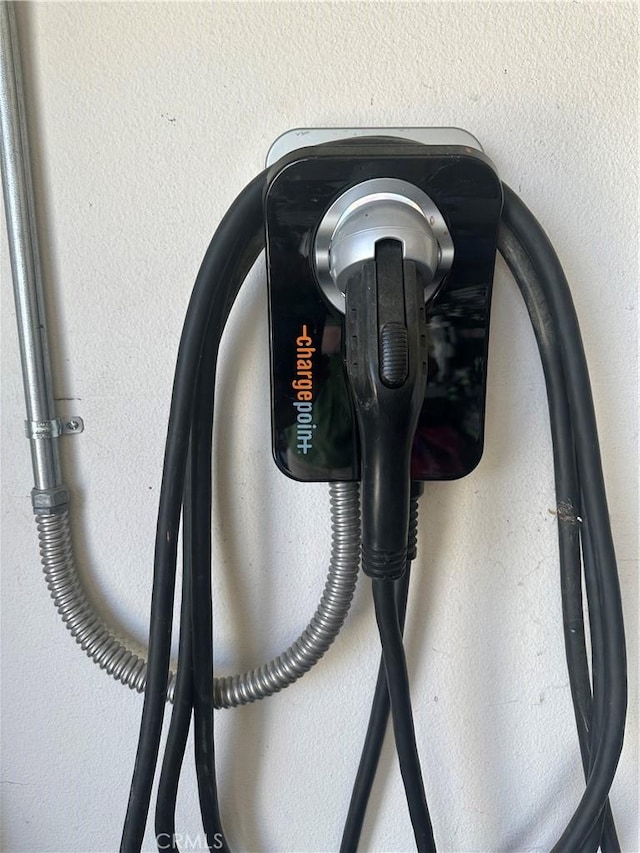 2408 Driftwood Dr, Rosamond, CA 93560 - garage view of stucco siding and electric vehicle charger