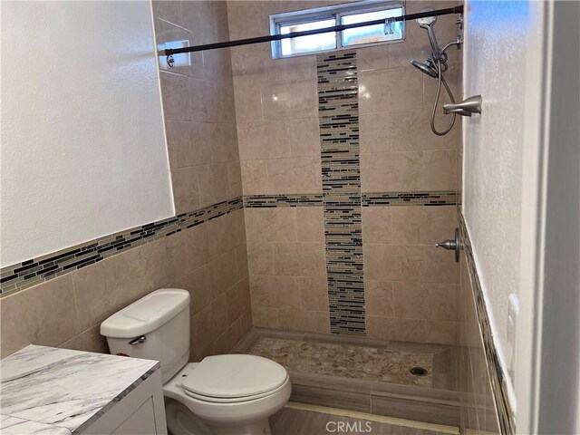 774 Josie St, Blythe, CA 92225 - full bath with tile walls, vanity, tiled shower, toilet, and a textured wall