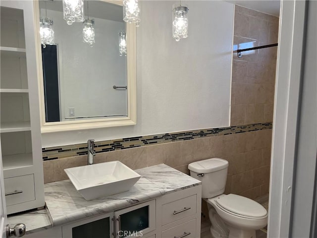 774 Josie St, Blythe, CA 92225 - bathroom featuring vanity, tiled shower, toilet, and tile walls