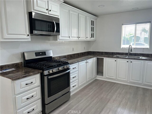 774 Josie St, Blythe, CA 92225 - kitchen featuring appliances with stainless steel finishes, a sink, white cabinetry, and light wood-style flooring