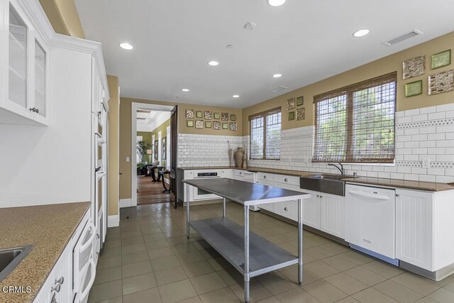 1542 Windshore Way, Oxnard, CA 93035 - kitchen featuring dishwasher, a sink, decorative backsplash, white cabinets, and recessed lighting