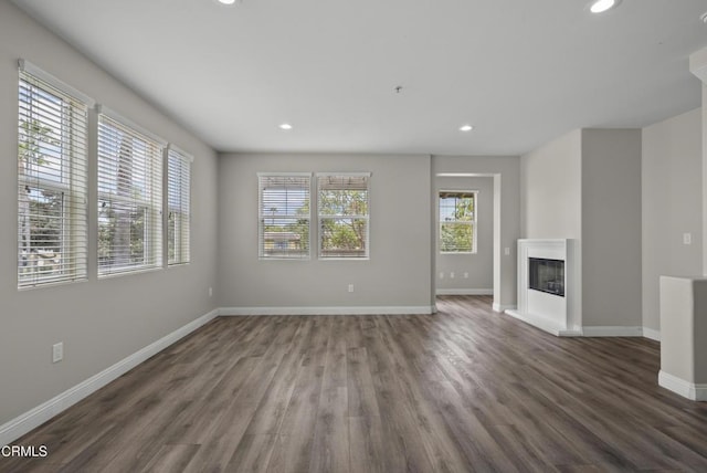 1542 Windshore Way, Oxnard, CA 93035 - unfurnished living room with wood finished floors, recessed lighting, baseboards, and a glass covered fireplace