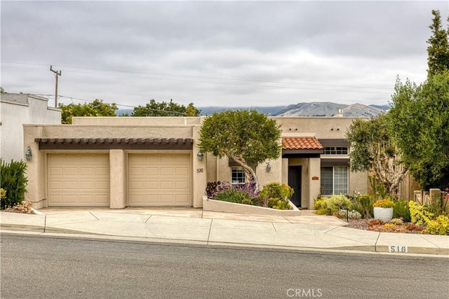516 Stoneridge Dr, San Luis Obispo, CA 93401 - pueblo-style house featuring stucco siding, concrete driveway, a tiled roof, and an attached garage
