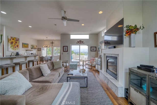 516 Stoneridge Dr, San Luis Obispo, CA 93401 - living area featuring wood finished floors, ceiling fan, recessed lighting, a premium fireplace, and a chandelier