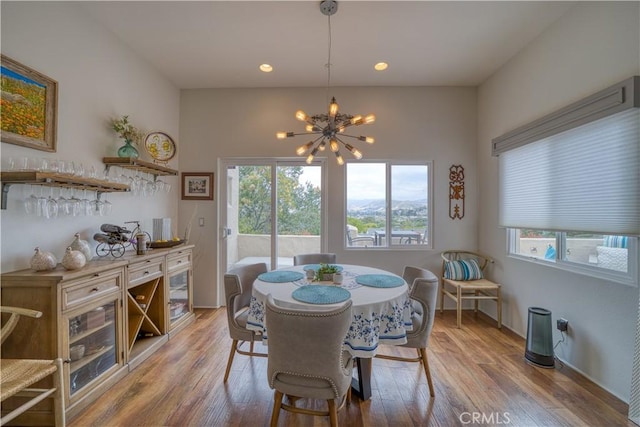 516 Stoneridge Dr, San Luis Obispo, CA 93401 - dining space with healthy amount of natural light, a chandelier, a bar, wood finished floors, and recessed lighting