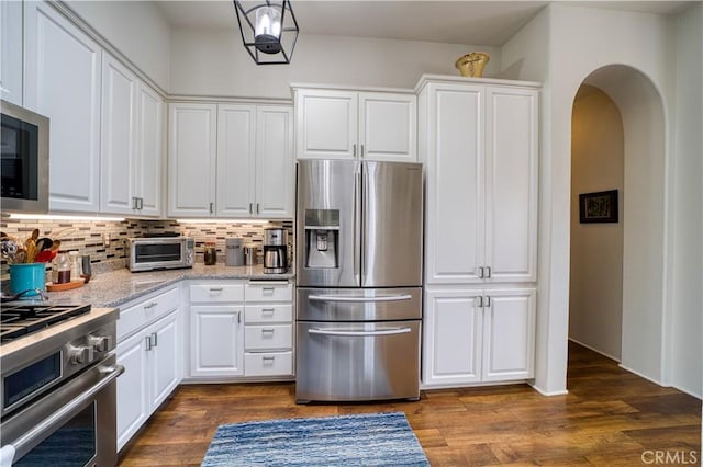 516 Stoneridge Dr, San Luis Obispo, CA 93401 - kitchen with stainless steel appliances, decorative backsplash, arched walkways, white cabinetry, and dark wood-type flooring