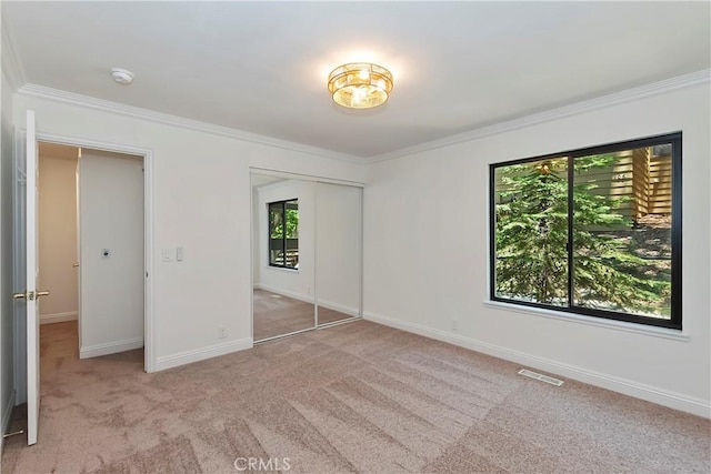 27657 Peninsula Dr Unit 131, Lake Arrowhead, CA 92352 - unfurnished bedroom with multiple windows, crown molding, carpet, and a closet
