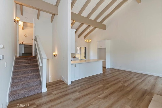 27657 Peninsula Dr Unit 131, Lake Arrowhead, CA 92352 - stairway featuring beamed ceiling, high vaulted ceiling, wood finished floors, and a chandelier