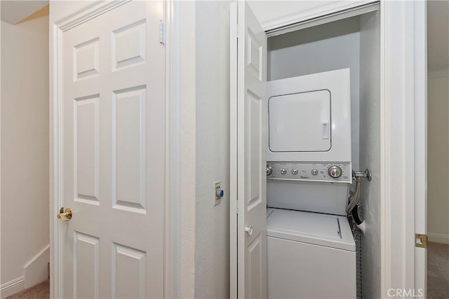 27657 Peninsula Dr Unit 131, Lake Arrowhead, CA 92352 - washroom featuring estacked washer and dryer and baseboards