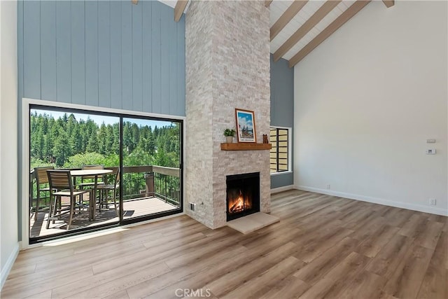 27657 Peninsula Dr Unit 131, Lake Arrowhead, CA 92352 - living area featuring high vaulted ceiling, beam ceiling, wood finished floors, and a fireplace