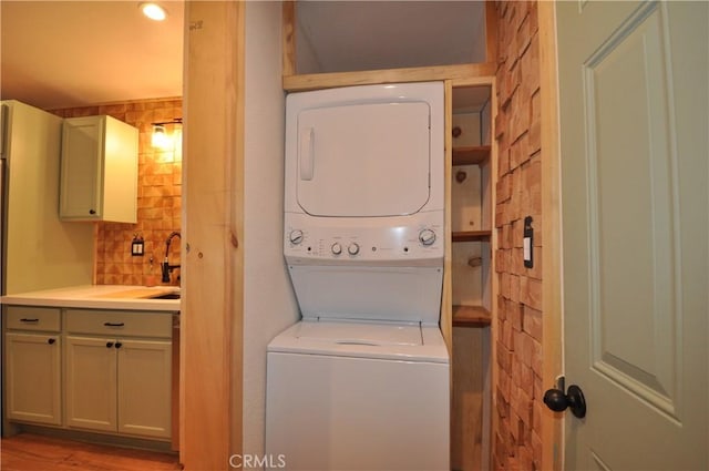 40122 Highland Rd, Big Bear Lake, CA 92315 - laundry room with stacked washer and clothes dryer and wood finished floors