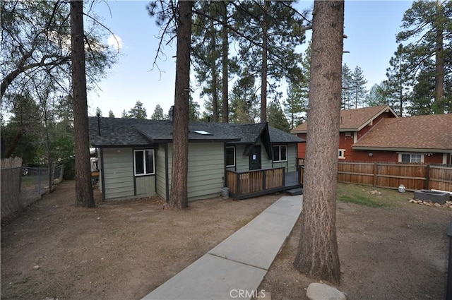40122 Highland Rd, Big Bear Lake, CA 92315 - ranch-style home with a fenced backyard, a deck, and a shingled roof