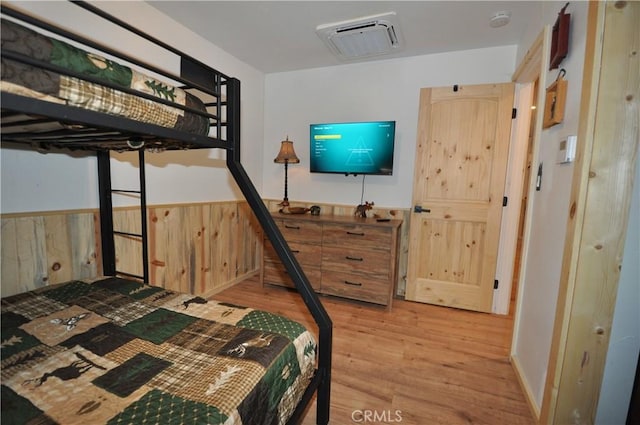 40122 Highland Rd, Big Bear Lake, CA 92315 - bedroom with light wood-style floors and a wainscoted wall