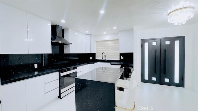 7401 Liberty Ave, Corona, CA 92881 - kitchen featuring range with electric stovetop, modern cabinets, wall chimney exhaust hood, tasteful backsplash, and white cabinets