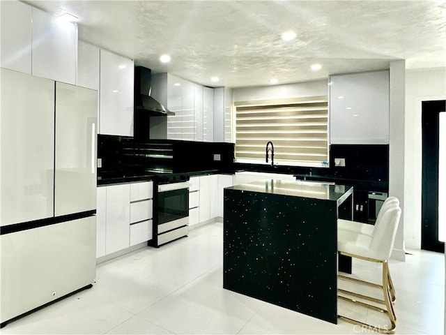 7401 Liberty Ave, Corona, CA 92881 - kitchen featuring freestanding refrigerator, wall chimney exhaust hood, electric range, modern cabinets, and white cabinets