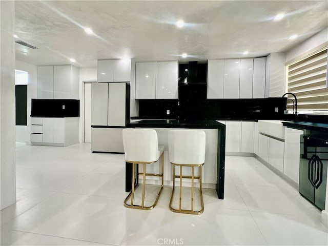 7401 Liberty Ave, Corona, CA 92881 - kitchen featuring modern cabinets, freestanding refrigerator, wall chimney range hood, white cabinets, and decorative backsplash