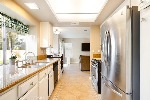 2424 Norte Vista Dr, Chino Hills, CA 91709 - kitchen featuring appliances with stainless steel finishes, a sink, light tile patterned floors, white cabinetry, and baseboards