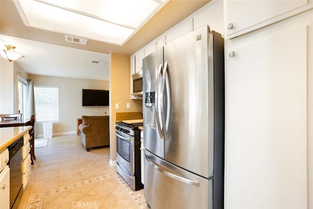 2424 Norte Vista Dr, Chino Hills, CA 91709 - kitchen featuring stainless steel appliances, light tile patterned floors, open floor plan, white cabinetry, and baseboards