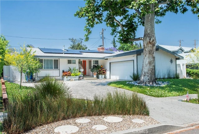 16827 Bircher St, Granada Hills, CA 91344 - ranch-style house featuring solar panels, an attached garage, and driveway