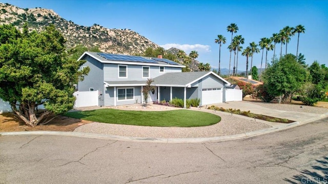 24920 Via Lopez Ct, Ramona, CA 92065 - traditional home featuring an attached garage, roof mounted solar panels, driveway, a chimney, and a mountain view