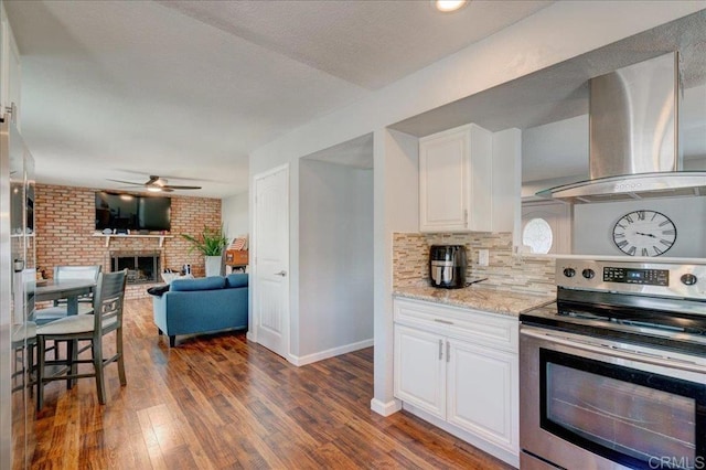 24920 Via Lopez Ct, Ramona, CA 92065 - kitchen with stainless steel electric range oven, wall chimney range hood, a ceiling fan, dark wood finished floors, and white cabinets