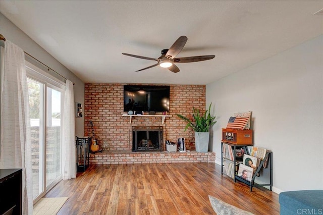 24920 Via Lopez Ct, Ramona, CA 92065 - living room with ceiling fan, wood finished floors, a brick fireplace, and baseboards