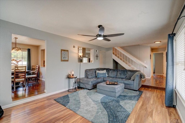 24920 Via Lopez Ct, Ramona, CA 92065 - living area with stairway, light wood finished floors, ceiling fan, a chandelier, and baseboards