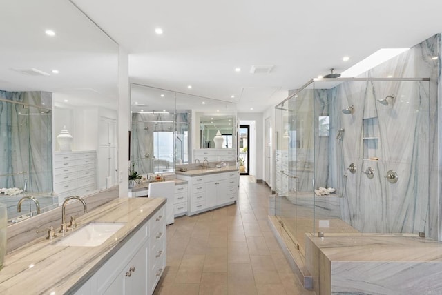 5067 Shore Dr, Carlsbad, CA 92008 - bathroom with a marble finish shower, vanity, and recessed lighting