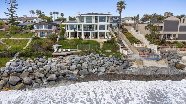 5067 Shore Dr, Carlsbad, CA 92008 - rear view of house featuring a residential view, a fenced backyard, a balcony, and stairs