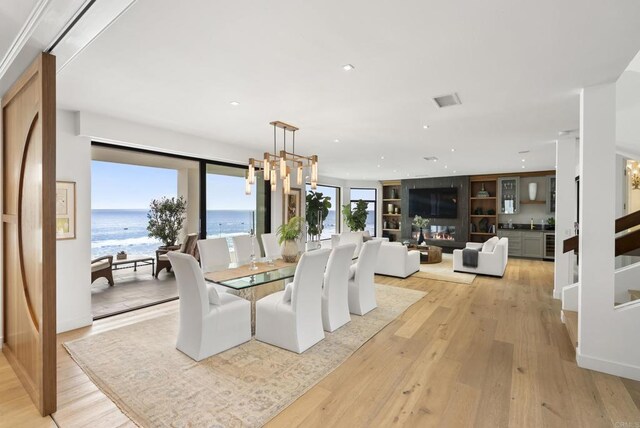 5067 Shore Dr, Carlsbad, CA 92008 - dining room with light wood-style flooring, a water view, recessed lighting, and beverage cooler