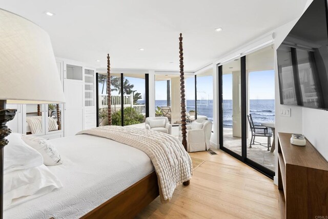 5067 Shore Dr, Carlsbad, CA 92008 - bedroom with access to exterior, multiple windows, light wood-type flooring, and floor to ceiling windows