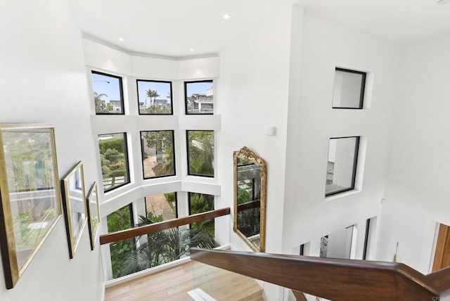5067 Shore Dr, Carlsbad, CA 92008 - staircase with wood finished floors and a high ceiling
