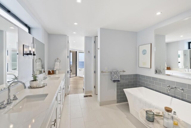 5067 Shore Dr, Carlsbad, CA 92008 - full bathroom featuring a freestanding bath, double vanity, tile patterned flooring, and recessed lighting