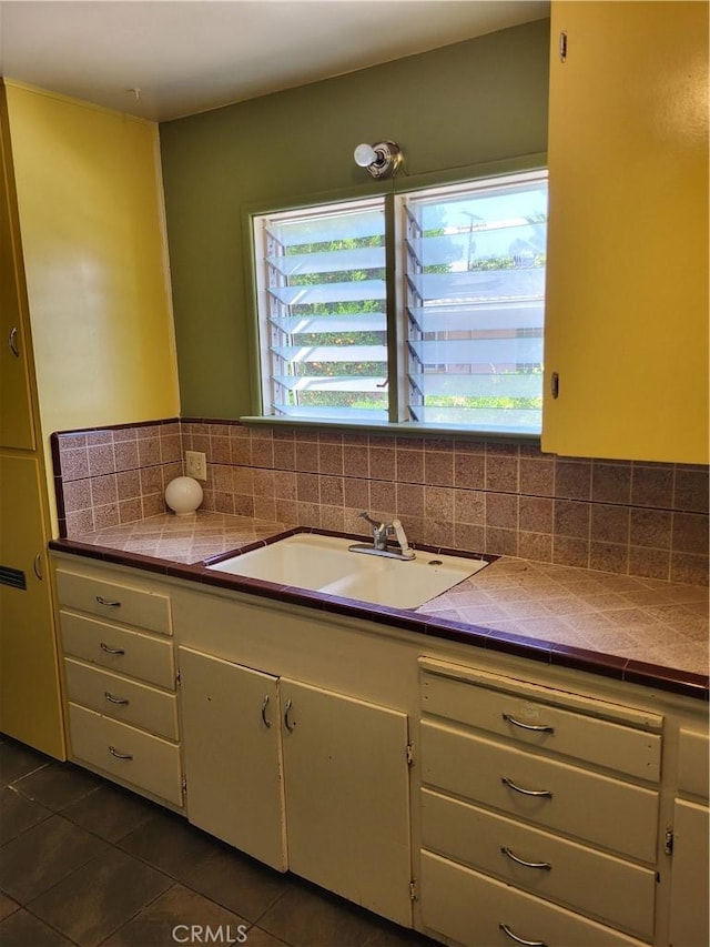 253 S Franklin St, Hemet, CA 92543 - bathroom featuring a sink, tile patterned floors, and decorative backsplash