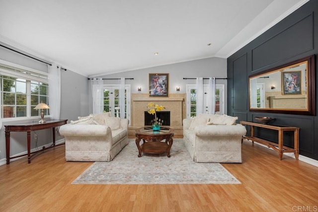 1093 Rancho Santa Fe Rd, Encinitas, CA 92024 - living room featuring french doors, lofted ceiling, light wood finished floors, and a fireplace with raised hearth